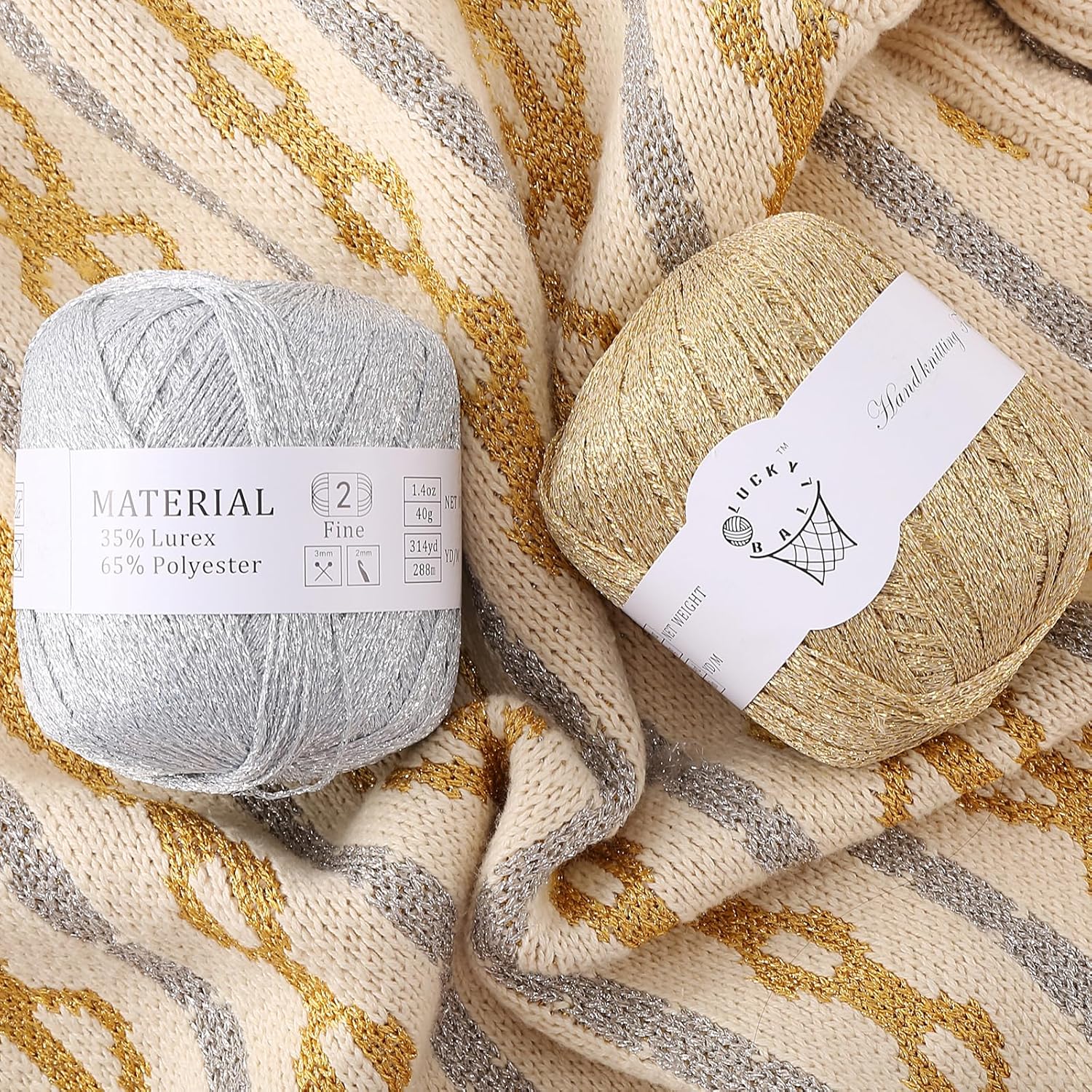 Silver and gold fancy yarn skeins on a cream knit fabric with metallic accents